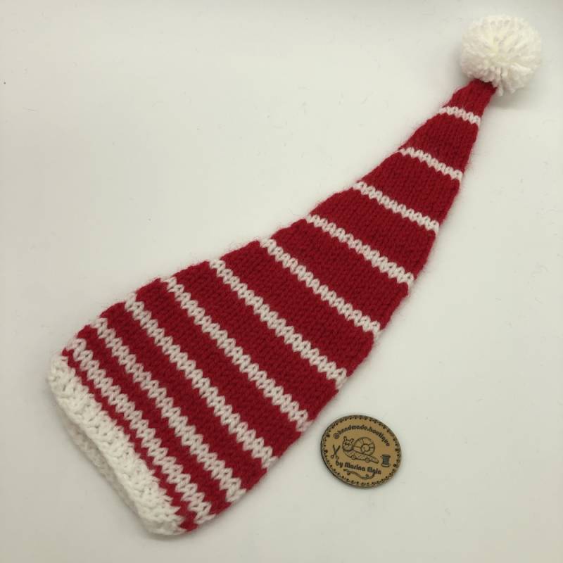 White hat with wide red stripes and white pompon