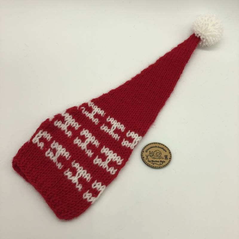 Red hat with white pattern and white pompon
