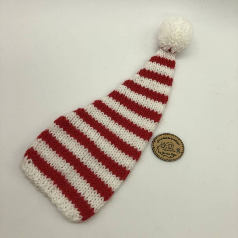 White hat with mid-wide red stripes and white pompon