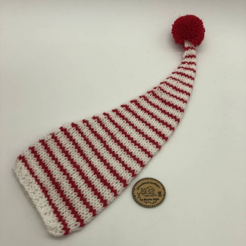 White hat with thin red stripes and red pompon