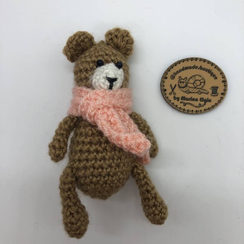 Brown bear with pink scarf