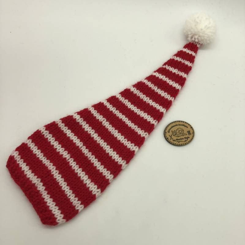 Red hat with thin white stripes and white pompon