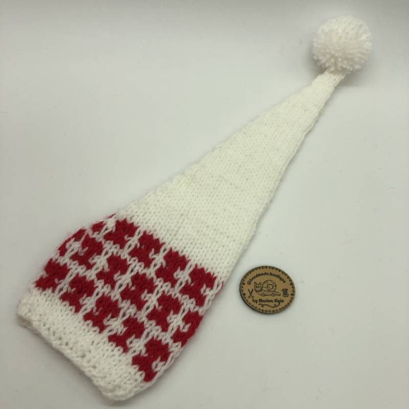 White hat with red pattern and white pompon