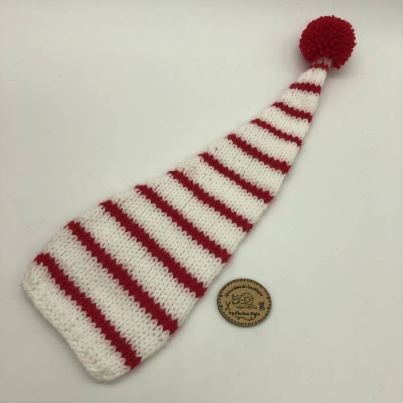 White hat with mid-wide, red stripes and red pompon