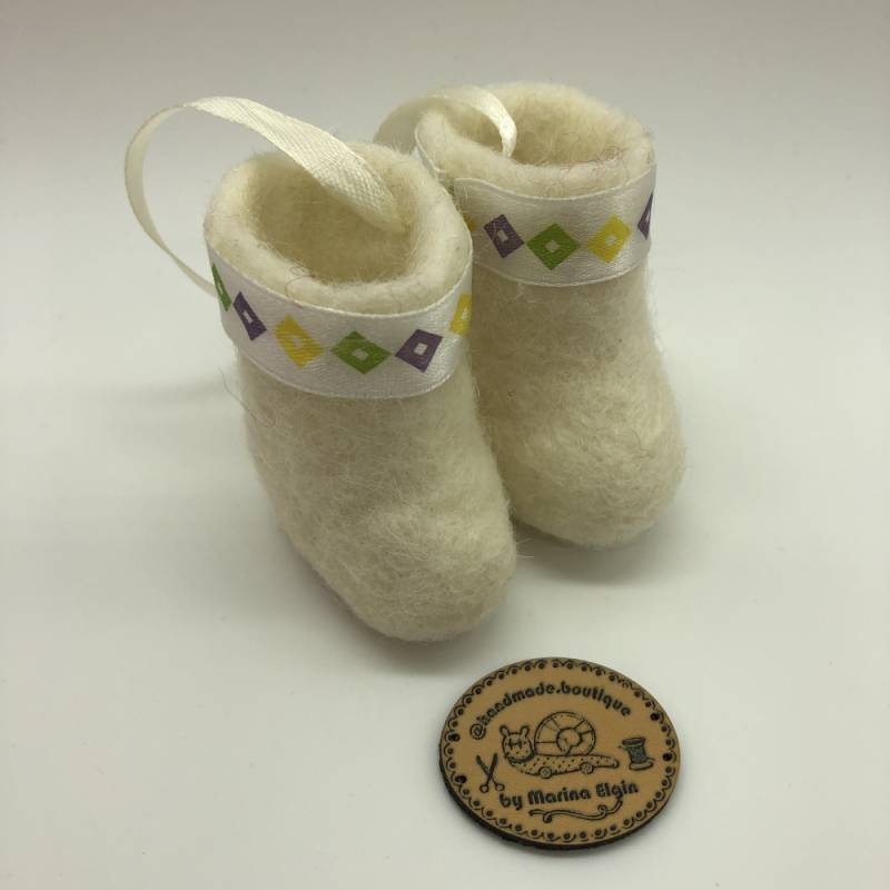 White felt shoes with yellow, green and purple pattern